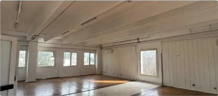 Bright room with wood flooring and large windows
