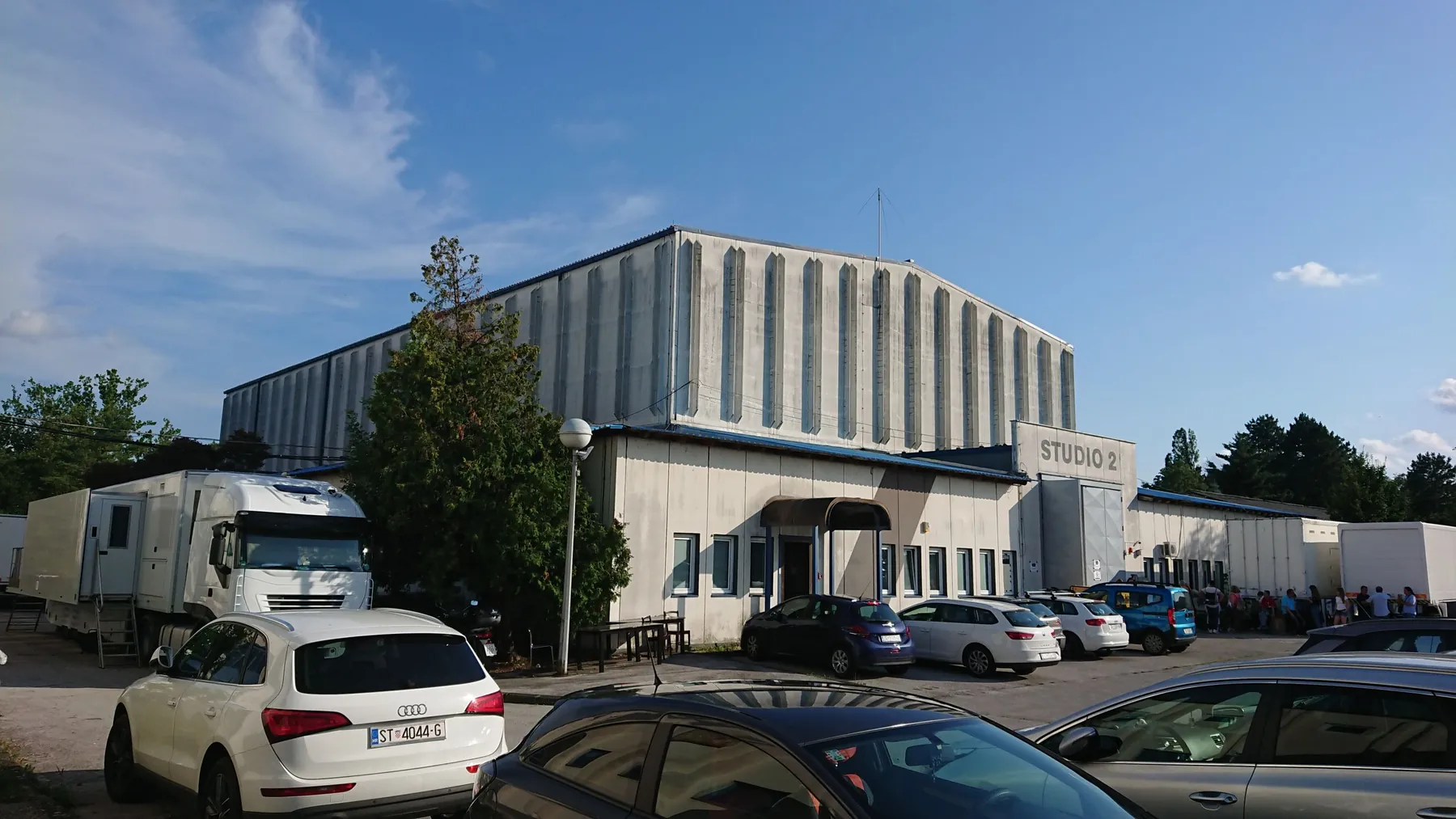 Studio 2 exterior with production vehicles and parking access